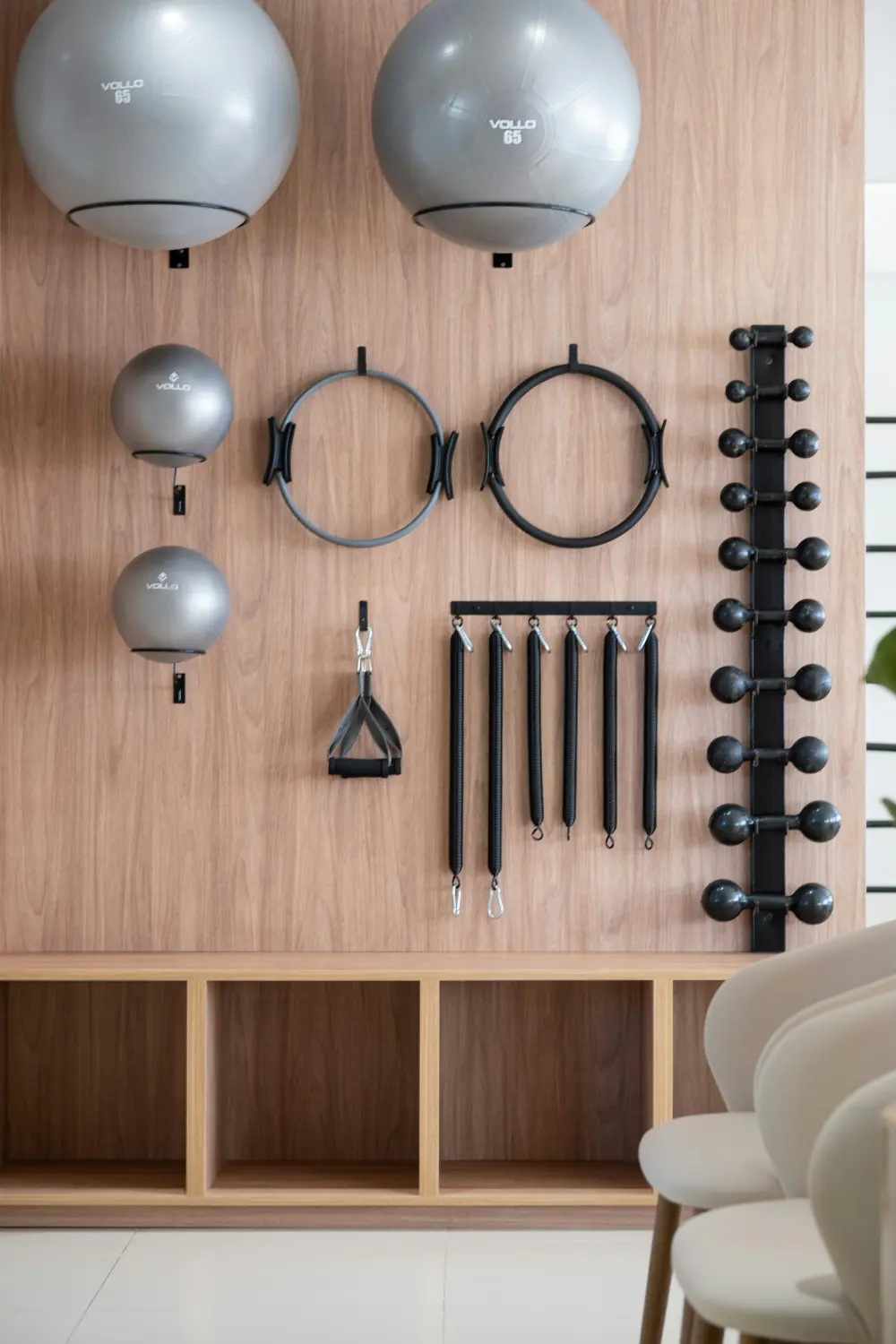 Exercise balls, resistance rings and bands hung neatly on a wooden wall in the treatment studio